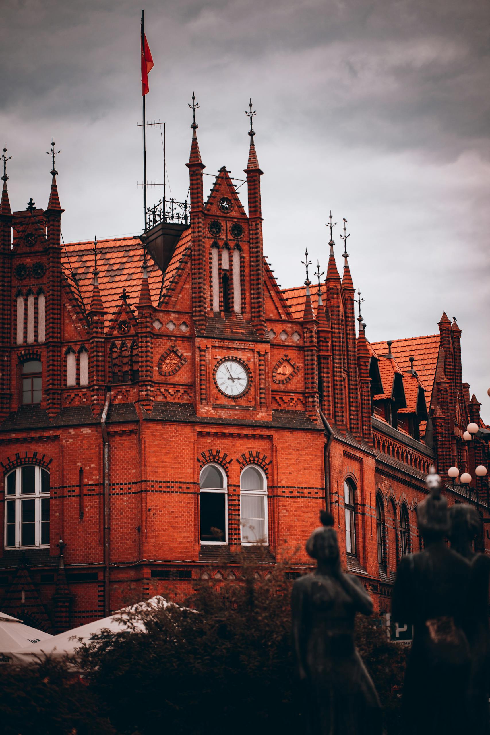 Explore the intricate architecture of the historic building in Bydgoszcz, Poland, featuring a prominent clock tower.
