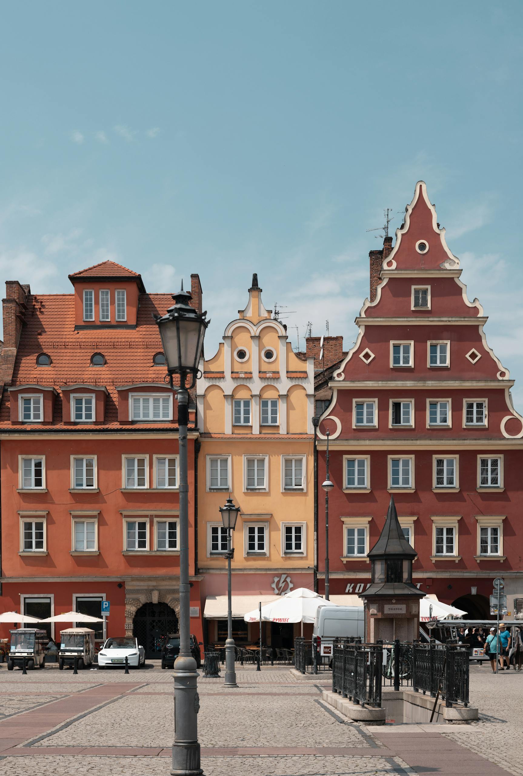 Vibrant facades of historic buildings in Wrocław Market Square under a clear blue sky.